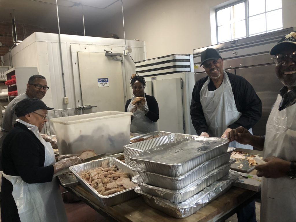 Photo of volunteers preparing Thanksgiving dinners.