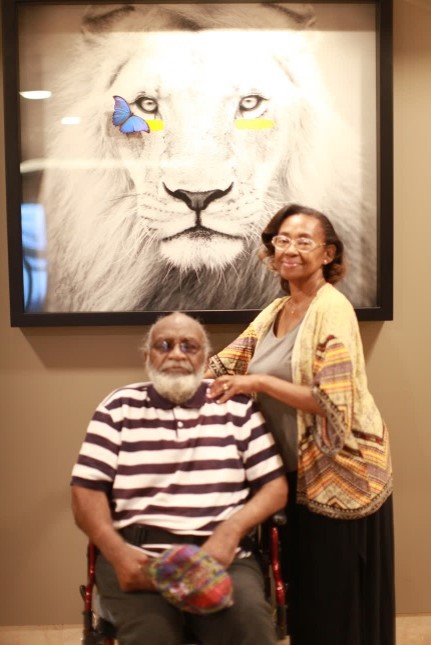 Pastor Joe and Gwynn in front of Lion painting.